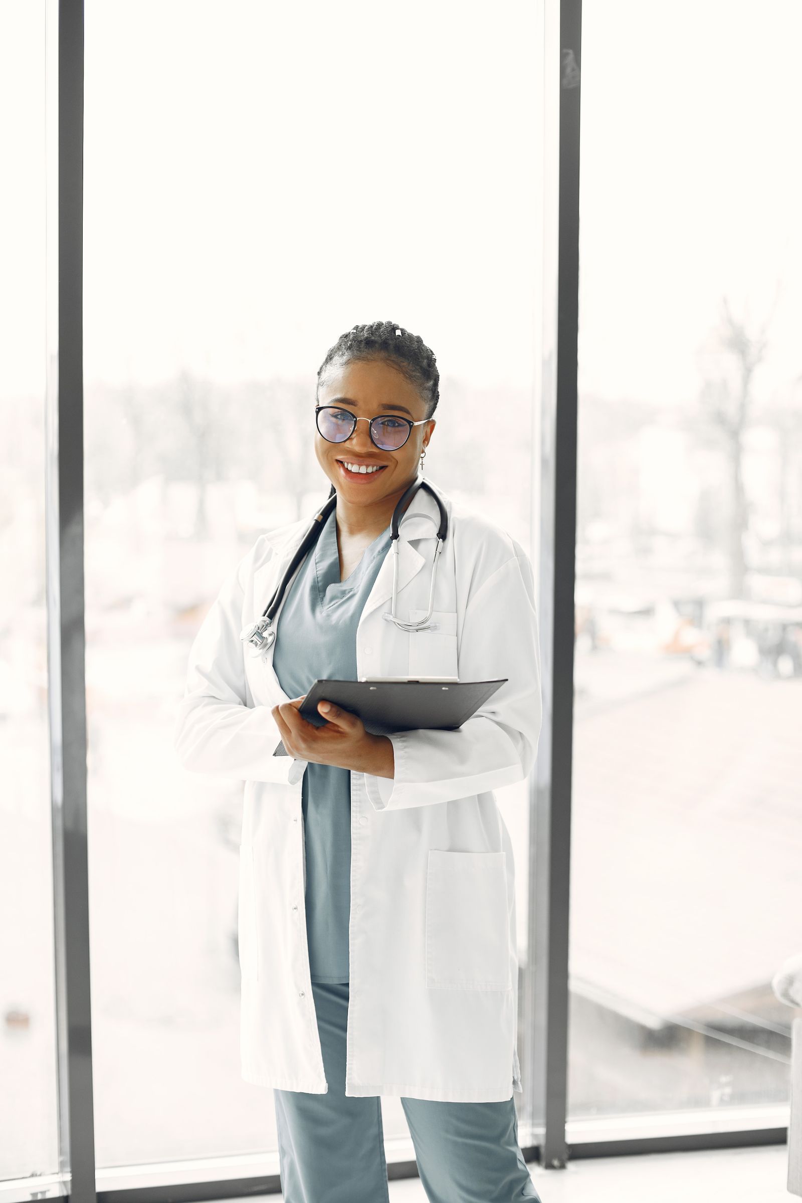 Healthcare professional holding a clipboard in a bright clinical setting